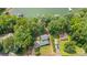 A serene aerial view of a lakeside property featuring lush greenery and a charming home outlined in red at 6836 Summer Hill Dr, Denver, NC 28037