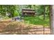 Secluded backyard with a fire pit and seating area, perfect for outdoor gatherings, surrounded by lush greenery at 6836 Summer Hill Dr, Denver, NC 28037