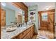 Bathroom with wood walls, a granite countertop, and a wooden framed mirror at 6836 Summer Hill Dr, Denver, NC 28037