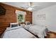 Bedroom featuring two twin beds, wood floors, and wooden walls at 6836 Summer Hill Dr, Denver, NC 28037