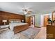 Spacious bedroom featuring wood walls, ceiling fan, and ensuite bathroom and closet at 6836 Summer Hill Dr, Denver, NC 28037
