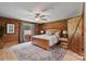 Cozy bedroom with wood paneled walls, a comfortable bed, and ample natural light at 6836 Summer Hill Dr, Denver, NC 28037
