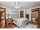 Bright bedroom features wood accents, a bed with decorative pillows, and wood floors at 6836 Summer Hill Dr, Denver, NC 28037