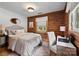 Bedroom with zebra rug, wood floors, a bed and a desk with a white chair at 6836 Summer Hill Dr, Denver, NC 28037