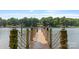 Scenic view from the wooden dock, featuring rope accents and clear water, perfect for enjoying lake living at 6836 Summer Hill Dr, Denver, NC 28037