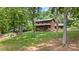 Beautiful log home with a spacious yard and a charming fire pit area at 6836 Summer Hill Dr, Denver, NC 28037