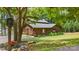 Log home with lush landscaping and a porte cochere, nestled in a serene setting near the water at 6836 Summer Hill Dr, Denver, NC 28037