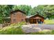 Charming log home featuring a large driveway and covered parking, surrounded by well-maintained greenery at 6836 Summer Hill Dr, Denver, NC 28037