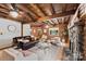 Comfortable living room featuring wooden ceilings, a fireplace, and a brown leather couch at 6836 Summer Hill Dr, Denver, NC 28037