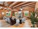 Open concept living room with beamed ceilings, hardwood floors and stone fireplace at 6836 Summer Hill Dr, Denver, NC 28037