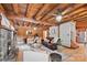 Spacious living room featuring a fireplace, wooden walls, hardwood floors, and white and leather furniture at 6836 Summer Hill Dr, Denver, NC 28037
