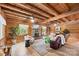 Open concept living room with beamed ceilings, hardwood floors and stone fireplace at 6836 Summer Hill Dr, Denver, NC 28037