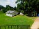 Spacious backyard with detached garage and sheds offering ample storage and outdoor living space at 714 Shady Dr, Albemarle, NC 28001