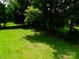 A large backyard with mature trees and green grass offers plenty of room to relax or play at 714 Shady Dr, Albemarle, NC 28001