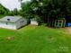 Aerial view of backyard with storage buildings and ample greenery at 714 Shady Dr, Albemarle, NC 28001