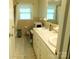 Bathroom featuring double sinks, vanity, and classic tile flooring at 714 Shady Dr, Albemarle, NC 28001