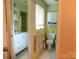 Charming yellow-tiled bathroom featuring a vanity, toilet, and a well-lit mirror offering a functional layout at 714 Shady Dr, Albemarle, NC 28001