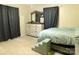 Relaxing bedroom featuring a bed with pet stairs, a dresser, and a window creating a welcoming space at 714 Shady Dr, Albemarle, NC 28001