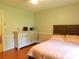Cozy bedroom with hardwood floors, featuring a bed with a wooden headboard and a dresser at 714 Shady Dr, Albemarle, NC 28001