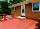 View of the entrance to this home, featuring the outdoor deck and a brick exterior at 714 Shady Dr, Albemarle, NC 28001