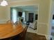 Dining room with a view of a living room, showcasing an elegant fireplace and decor at 714 Shady Dr, Albemarle, NC 28001