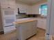 Bright kitchen showcasing white cabinetry, modern appliances, and a functional island with a convenient paper towel holder at 714 Shady Dr, Albemarle, NC 28001