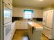 Traditional white kitchen featuring ample cabinet space and a functional island at 714 Shady Dr, Albemarle, NC 28001