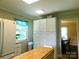 Spacious kitchen with white cabinets, modern appliances, and an island extending to an adjoining dining area at 714 Shady Dr, Albemarle, NC 28001