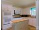 Well-equipped kitchen with a double oven, microwave, and island, complemented by white cabinets for a clean look at 714 Shady Dr, Albemarle, NC 28001