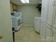 Spacious laundry room featuring a washer, dryer, sink, and ample storage cabinets for convenience at 714 Shady Dr, Albemarle, NC 28001