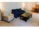 Inviting living room featuring neutral walls, plush seating arrangements, and a view into the adjacent dining space at 714 Shady Dr, Albemarle, NC 28001