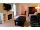 Cozy living room with a fireplace, built-in shelving, comfortable seating, and stylish decor providing a warm atmosphere at 714 Shady Dr, Albemarle, NC 28001