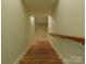 Staircase leading to a tiled landing with a door offering access to the lower level of the home at 714 Shady Dr, Albemarle, NC 28001