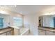 Elegant bathroom with granite counters, double sinks, and large soaking tub under a bright window at 7172 Sylvan Retreat Dr, Denver, NC 28037