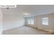 Spacious bedroom with two windows, carpet floors, and bright lighting from flush mount ceiling light at 7172 Sylvan Retreat Dr, Denver, NC 28037