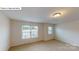 Well-lit bedroom with two large windows, neutral walls, and plush carpet flooring at 7172 Sylvan Retreat Dr, Denver, NC 28037
