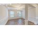 Open dining room with coffered ceiling, wood floors, wainscoting and lots of natural light at 7172 Sylvan Retreat Dr, Denver, NC 28037