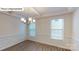 Formal dining room with wood floors, chandelier, coffered ceiling, and wainscoting at 7172 Sylvan Retreat Dr, Denver, NC 28037