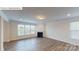 Bright living room featuring a fireplace, large windows, and wood-look flooring at 7172 Sylvan Retreat Dr, Denver, NC 28037