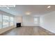 Spacious living room with fireplace, large windows, and modern flooring at 7172 Sylvan Retreat Dr, Denver, NC 28037