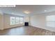 Bright living room featuring a fireplace, large windows, and wood-look flooring at 7172 Sylvan Retreat Dr, Denver, NC 28037