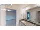 Well-lit bathroom with a granite countertop, vanity, and stylish lighting fixture at 7190 Sylvan Retreat Dr, Denver, NC 28037