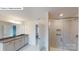 Bright bathroom featuring granite counters, double vanity, tile floors, and glass enclosed shower at 7190 Sylvan Retreat Dr, Denver, NC 28037