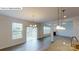 Open-concept living space with hardwood floors, ample natural light, a fireplace, and view into the kitchen at 7190 Sylvan Retreat Dr, Denver, NC 28037