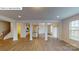 Open-concept living space featuring hardwood floors, and view into an open kitchen with an island at 7190 Sylvan Retreat Dr, Denver, NC 28037