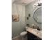 Traditional bathroom includes a pedestal sink, framed mirror and sconce lighting at 8350 Brickle Ln, Huntersville, NC 28078