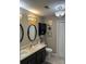 Bathroom featuring double sinks, stylish mirrors, vanity and modern lighting at 8350 Brickle Ln, Huntersville, NC 28078