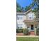 Charming two-story townhouse with well-maintained landscaping and a welcoming front entrance at 8350 Brickle Ln, Huntersville, NC 28078