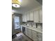 Bright kitchen with white cabinets, modern appliances, and ample counter space for meal preparation at 8350 Brickle Ln, Huntersville, NC 28078