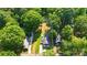 An aerial view of the property showcasing the house, yard, and surrounding mature trees at 840 10Th Street Nw Blvd, Hickory, NC 28601